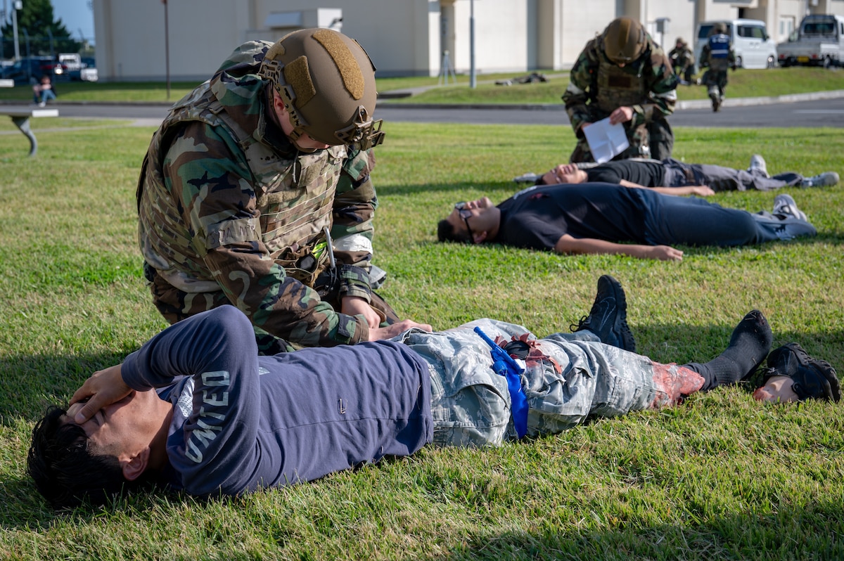 A U.S. Air Force Airman assigned to the 35th Civil Engineer Squadron performs tactical combat casualty care on a simulated injured member during Exercise Beverly Sunrise 26-1 (BS26-1) at Misawa Air Base, Japan, Oct. 15, 2025. Exercises like BS26-1 ensure 35th Fighter Wing personnel remain proficient in lifesaving skills that enable mission continuity and operational success. (U.S. Air Force photo by Senior Airman Brittany Russell)