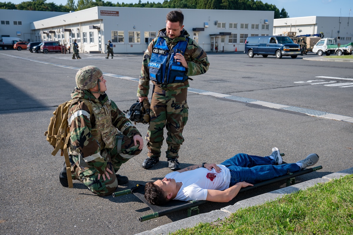 U.S. Air Force Airmen assigned to the 35th Civil Engineer Squadron discuss tactical combat casualty care procedures during Exercise Beverly Sunrise 26-1 at Misawa Air Base, Japan, Oct. 15, 2025. Hands-on casualty care scenarios reinforce the importance of rapid, decisive action necessary to sustain combat effectiveness in real-world operations. (U.S. Air Force photo by Senior Airman Brittany Russell)