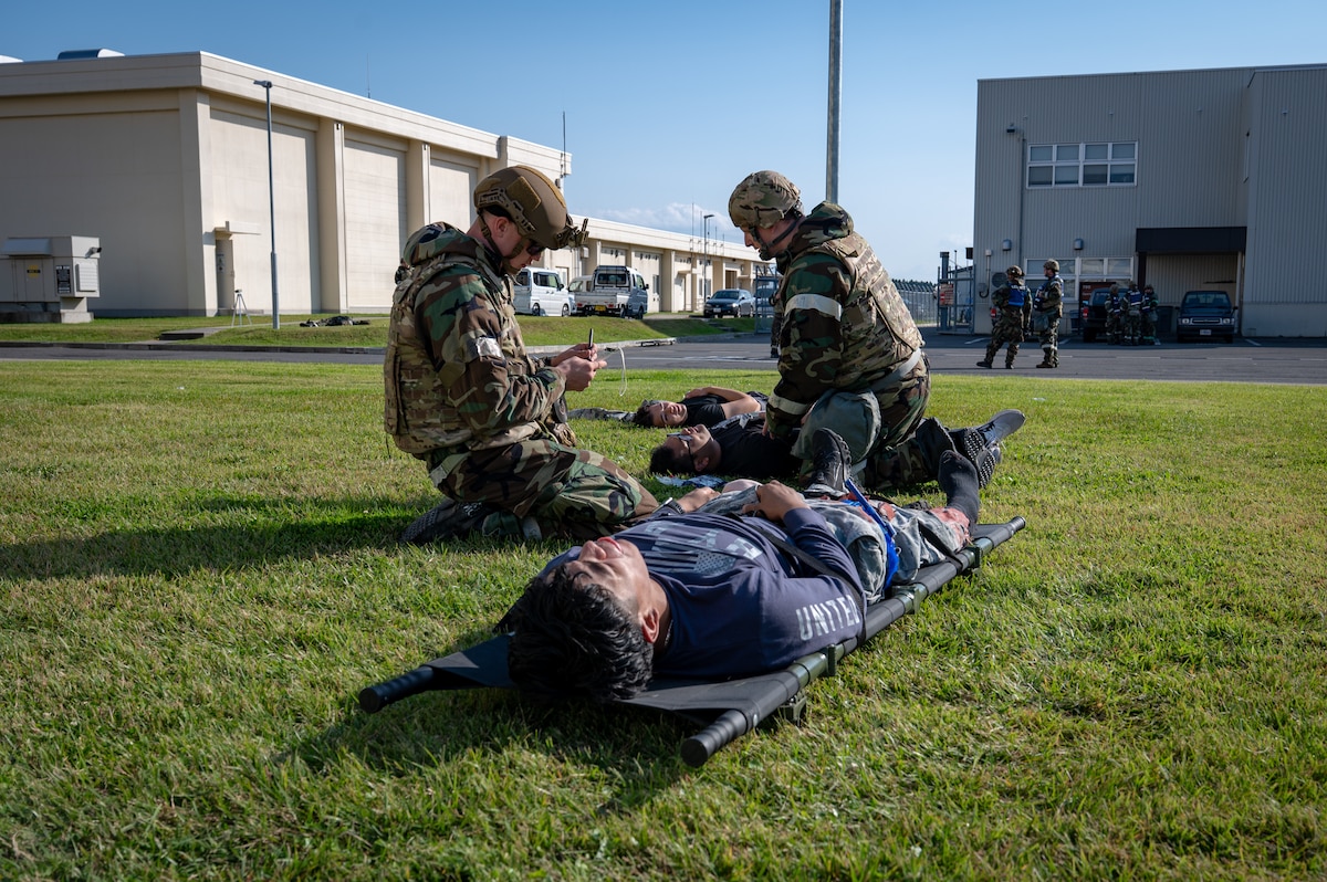 U.S. Air Force Airmen assigned to the 35th Civil Engineer Squadron perform tactical combat casualty care (TCCC) procedures to simulated injured members during Exercise Beverly Sunrise 26-1 at Misawa Air Base, Japan, Oct. 15, 2025. By practicing TCCC, 35th Fighter Wing Airmen sharpened their ability to deliver lifesaving aid under pressure, ensuring force preservation in any contingency. (U.S. Air Force photo by Senior Airman Brittany Russell)