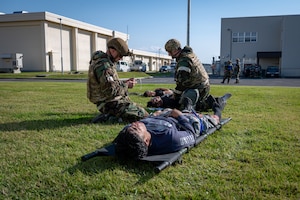U.S. Air Force Airmen assigned to the 35th Civil Engineer Squadron perform tactical combat casualty care (TCCC) procedures to simulated injured members during Exercise Beverly Sunrise 26-1 at Misawa Air Base, Japan, Oct. 15, 2025. By practicing TCCC, 35th Fighter Wing Airmen sharpened their ability to deliver lifesaving aid under pressure, ensuring force preservation in any contingency. (U.S. Air Force photo by Senior Airman Brittany Russell)