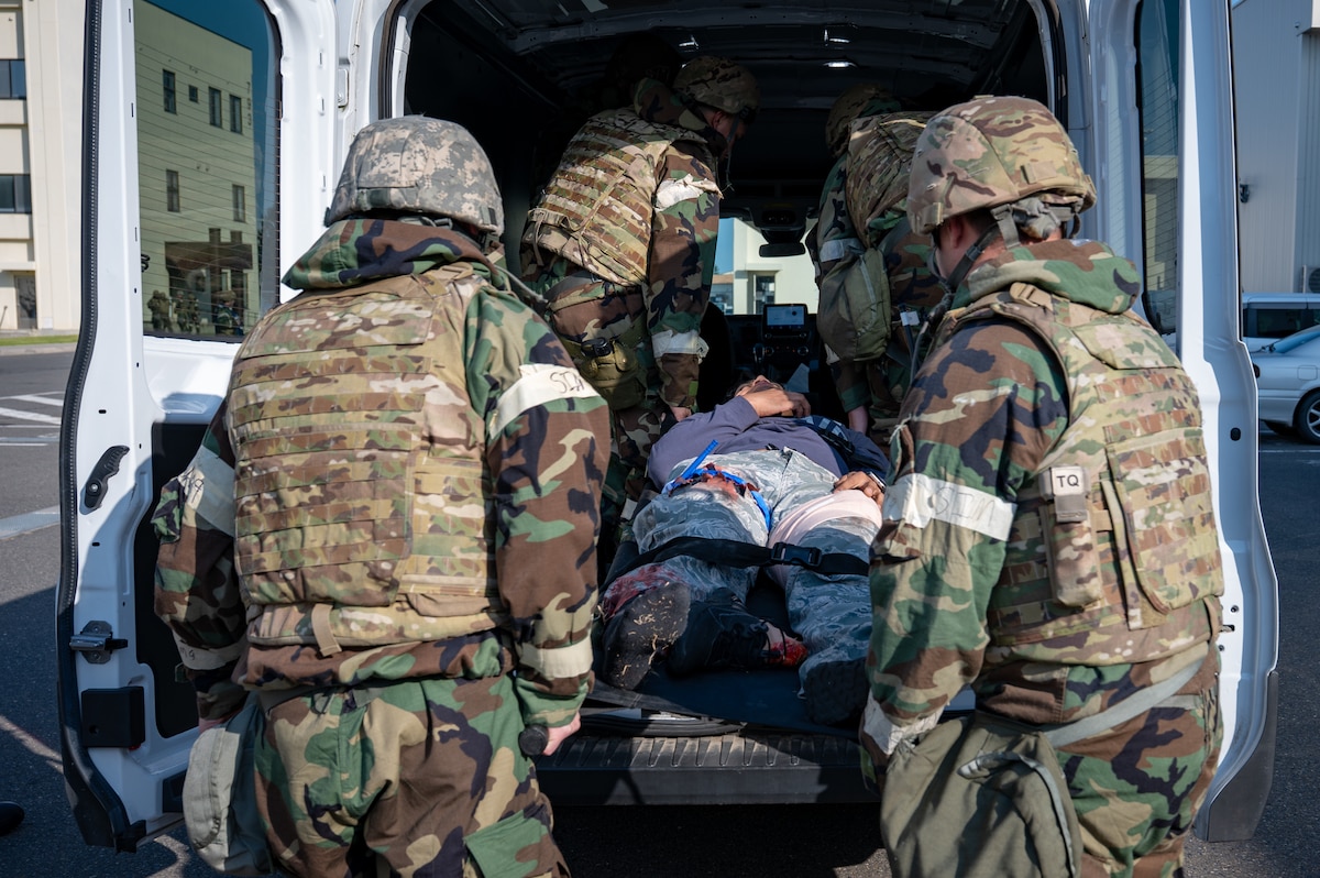U.S. Air Force Airmen assigned to the 35th Civil Engineer Squadron load a simulated injured member into a transport vehicle during Exercise Beverly Sunrise 26-1 at Misawa Air Base, Japan, Oct. 15, 2025. Hands-on casualty care scenarios reinforce the importance of rapid, decisive action necessary to sustain combat effectiveness in real-world operations. (U.S. Air Force photo by Senior Airman Brittany Russell)