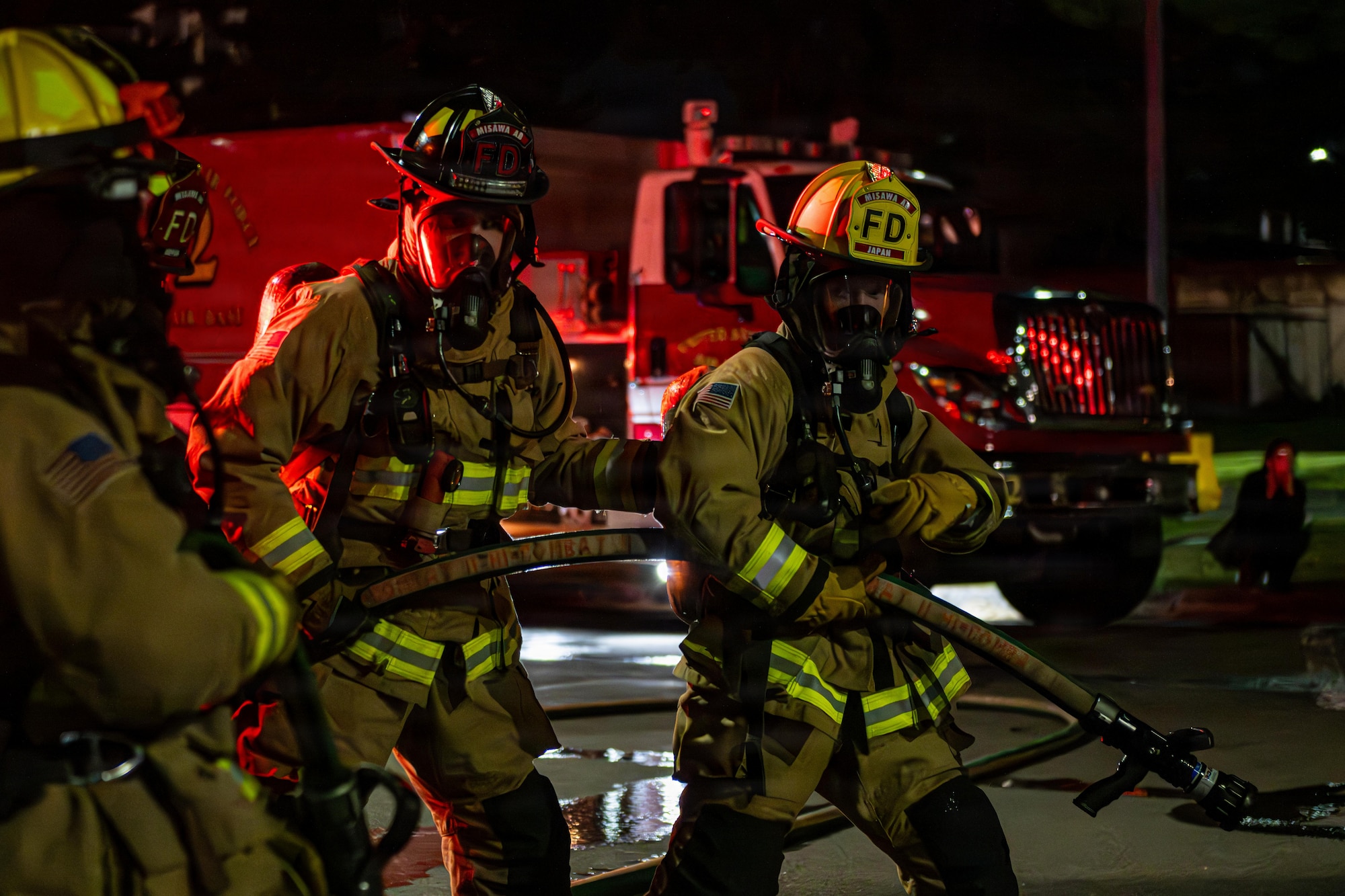U.S. Air Force Airmen assigned to the 35th Civil Engineer Squadron prepare to put out a fire on a simulated burning aircraft during Fire Prevention Week 2025.