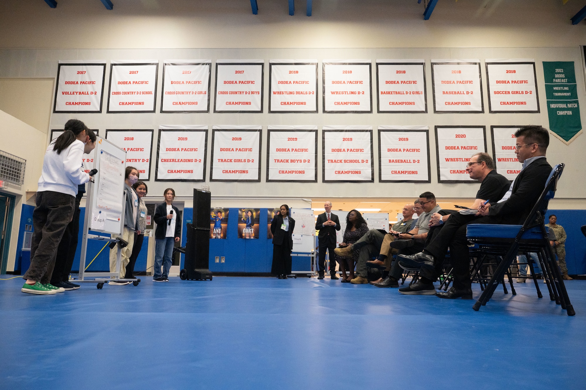 A group of students presents to an audience.