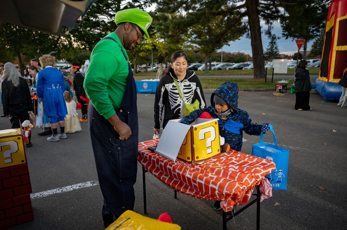 A participant picks up candy during Trunk or Treat at Misawa Air Base, Japan, Oct. 24, 2025. Trunk or Treat reflected the 35th Fighter Wing’s mission to build a stronger, more connected community through quality events that bring people together. (U.S. Air Force photo by Senior Airman Brittany Russell)