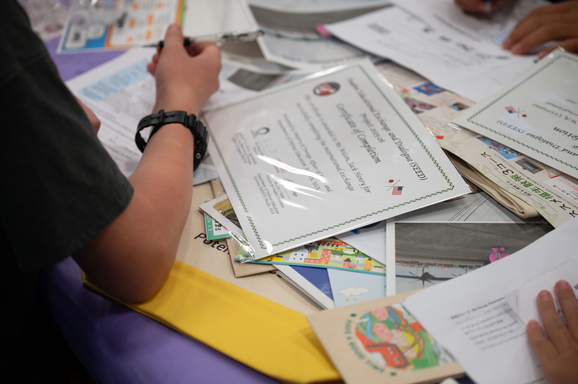 Students write on surveys.