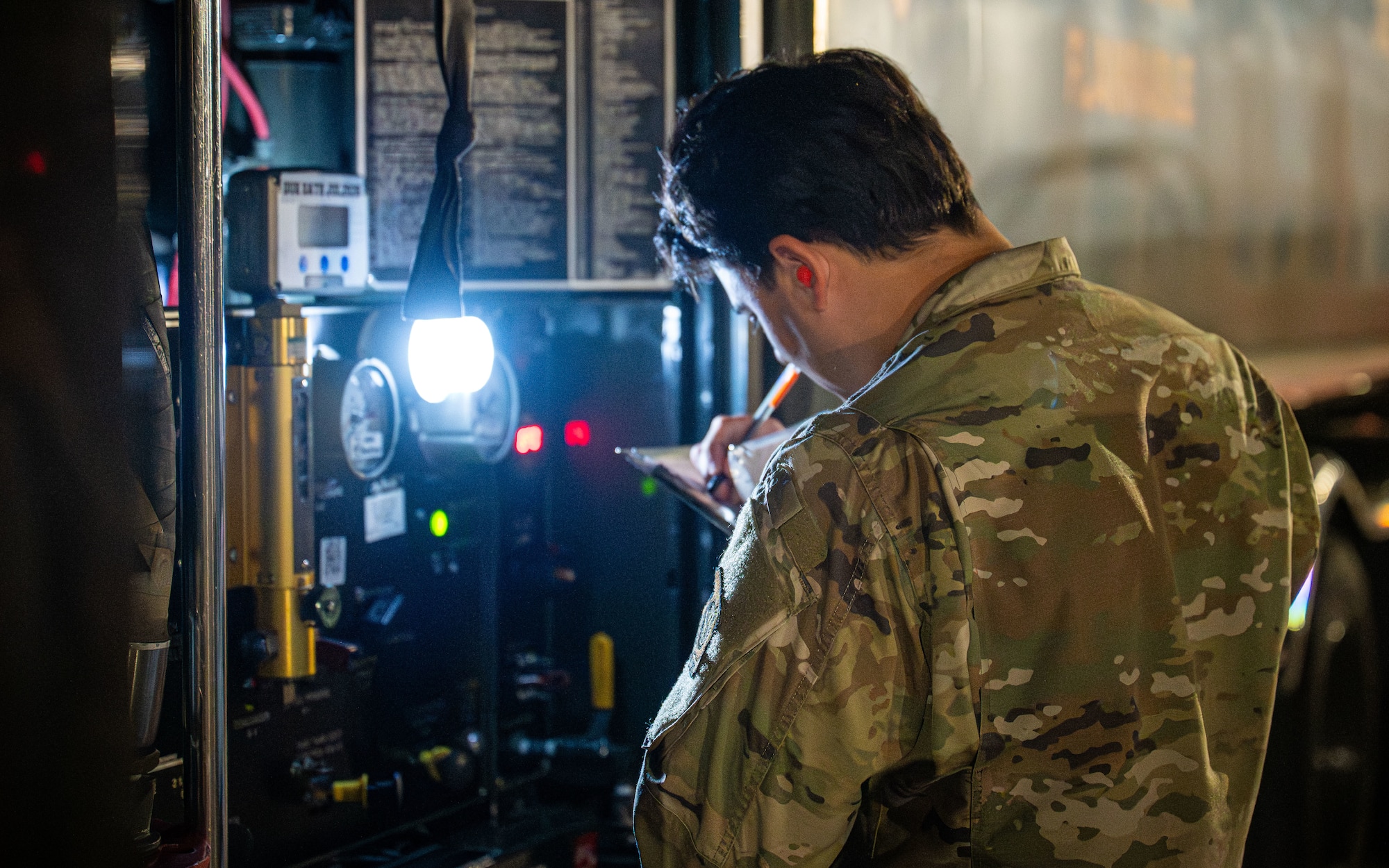 airman inspects truck.