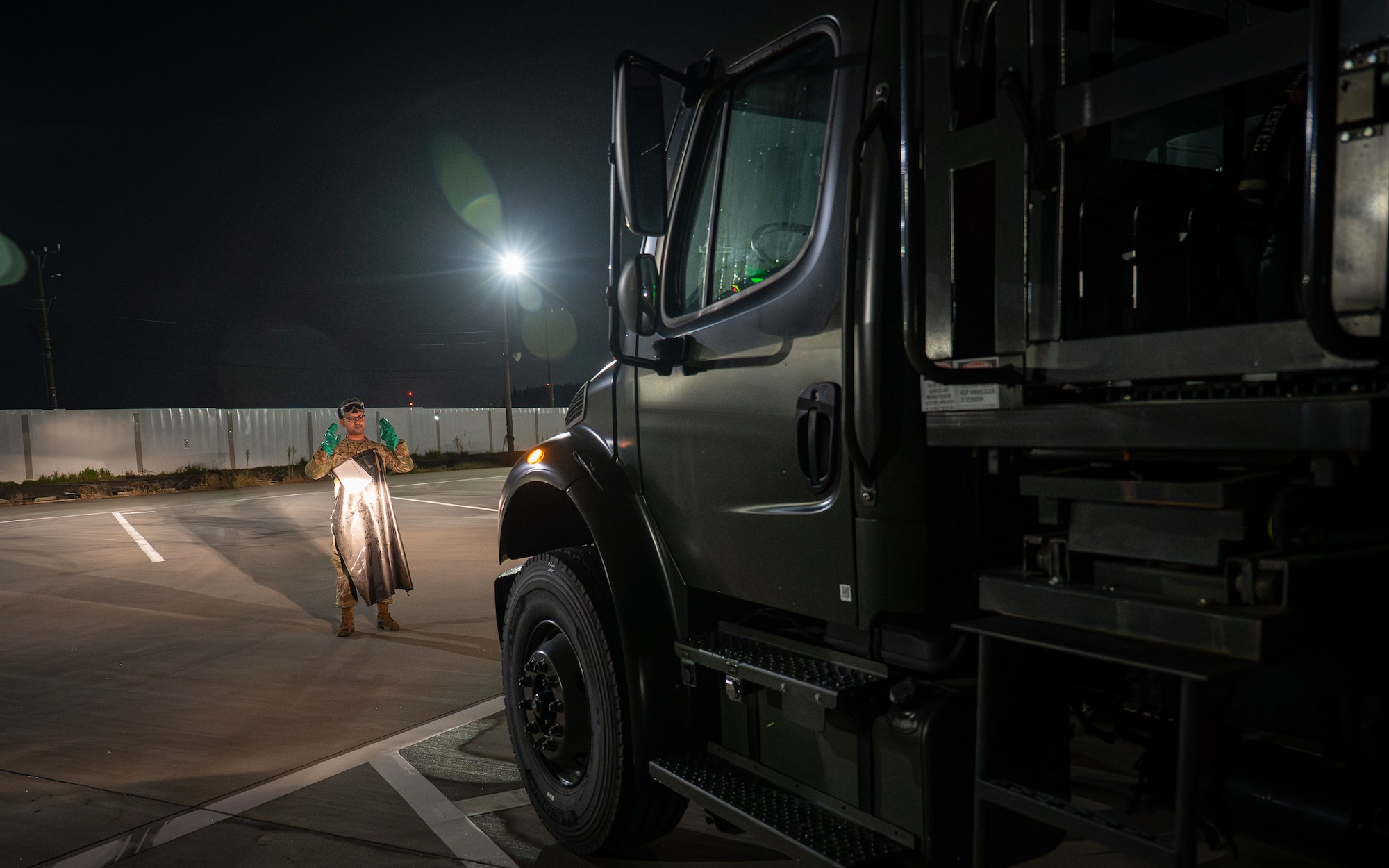 airman directs fuels truck.