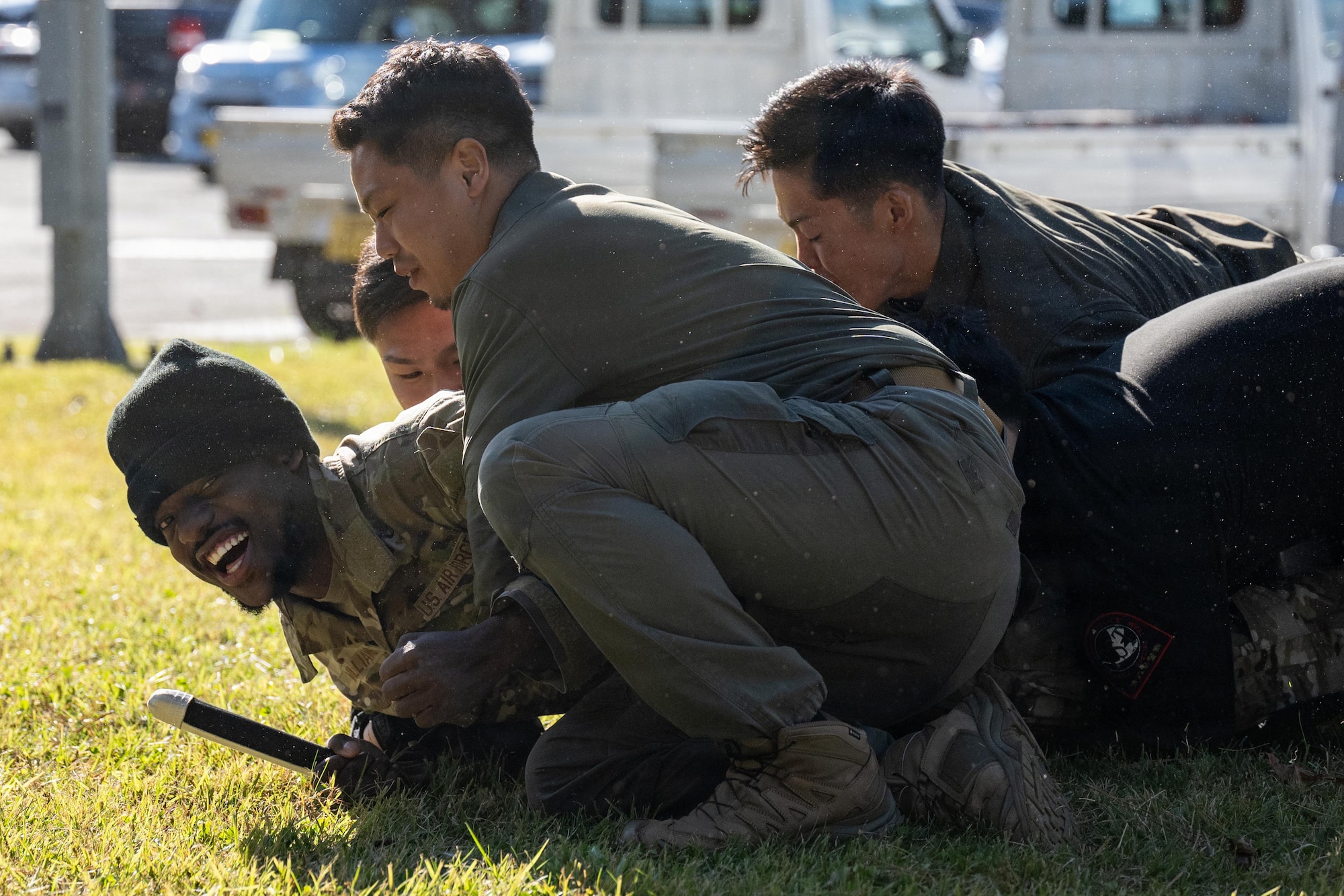 U.S. Air Force Airman 1st Class Ricky Williams, 35th Security Forces defender, is taken down by Japanese National Police special investigation team members as part of a knife takedown demonstration during a joint special weapons and tactics training event.