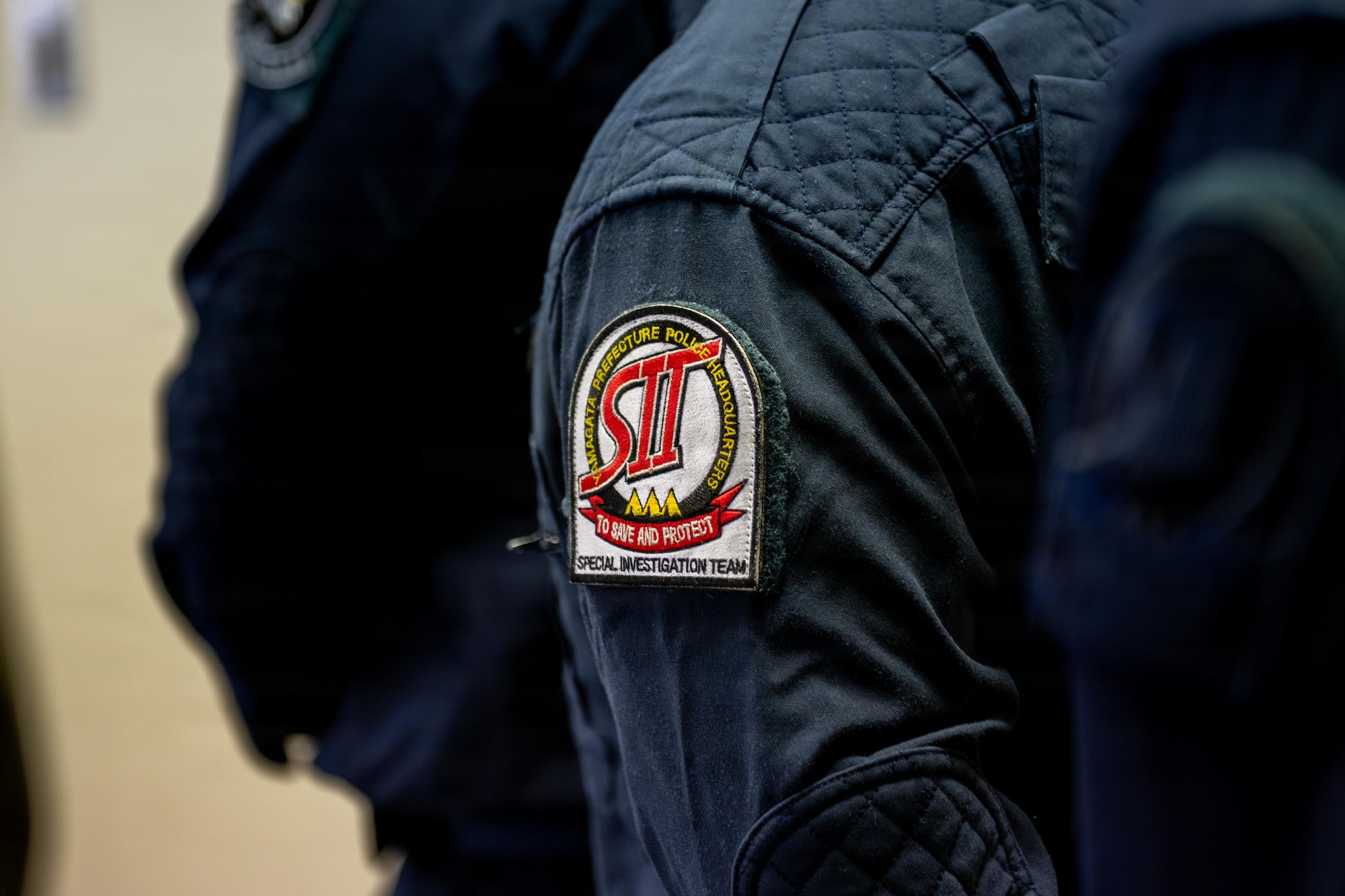 A Japanese National Police Special Investigation Team patch is displayed during a joint special weapons and tactics training event.