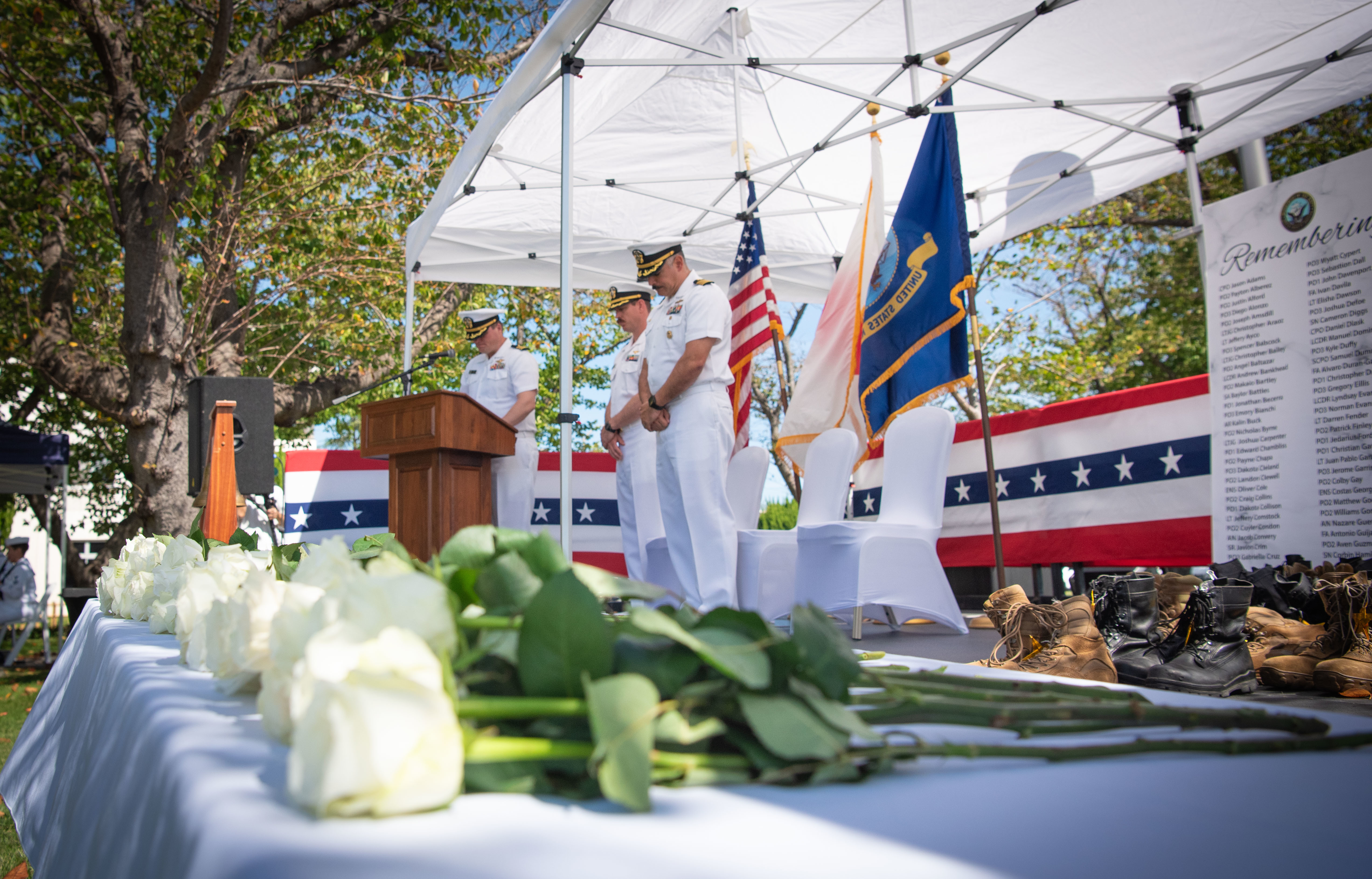 Cmdr. Daniel Clark, left, chaplain, Cmdr. Patrick Gutierrez, Chief Staff Officer commander, Fleet Activities Yokosuka (CFAY), and Capt. Jonathan Hopkins, Commanding Officer, CFAY, bow their heads in prayer during a Bells Across America for Fallen Service Members ceremony held onboard Fleet Activities Yokosuka, Japan, September 25, 2025.