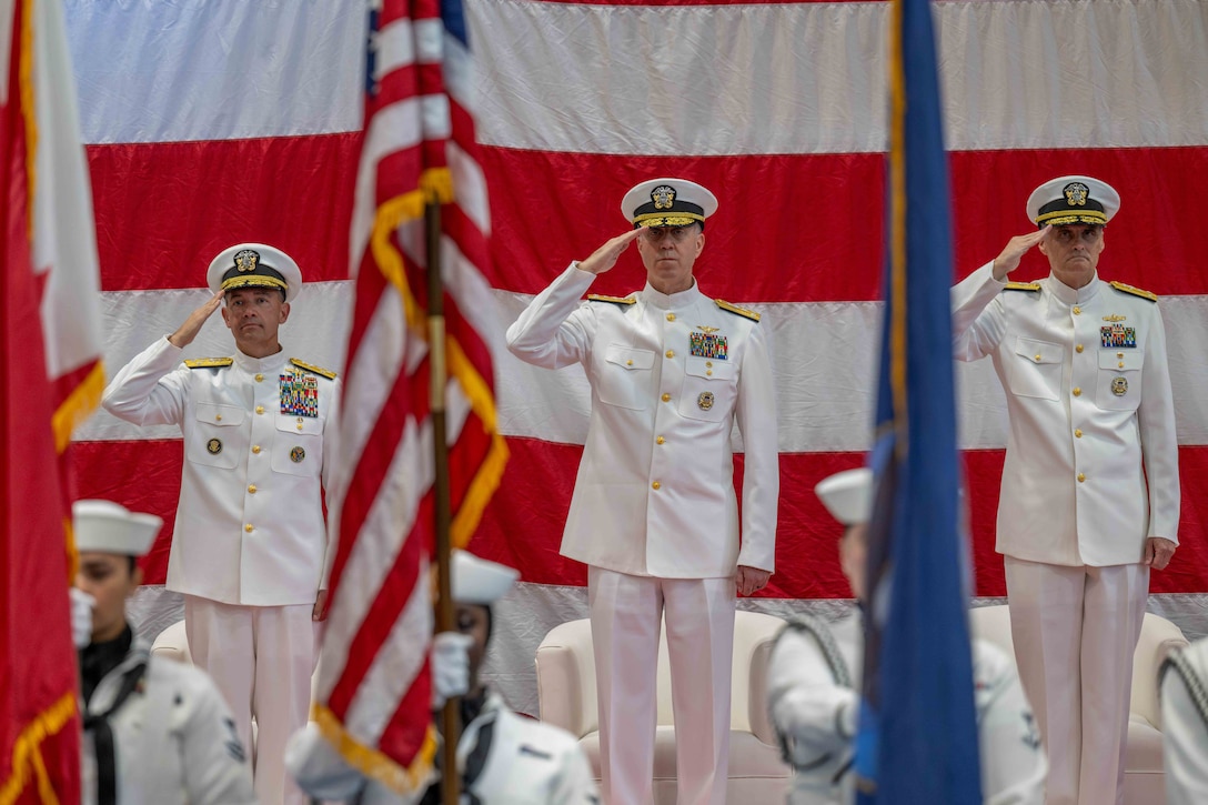 MANAMA, Bahrain (Oct. 5, 2025) U.S. Navy Adm. Brad Cooper, commander of U.S. Central Command, left; Vice Adm. George Wikoff, outgoing commander of U.S. Naval Forces Central Command (NAVCENT), U.S. 5th Fleet and Combined Maritime Forces (CMF), center; and Vice Adm. Kurt Renshaw, incoming commander of NAVCENT, U.S. 5th Fleet and CMF, right; render honors during a change of command ceremony in Manama, Bahrain (U.S. Navy photo by Mass Communication Specialist 2nd Class Iain Page)