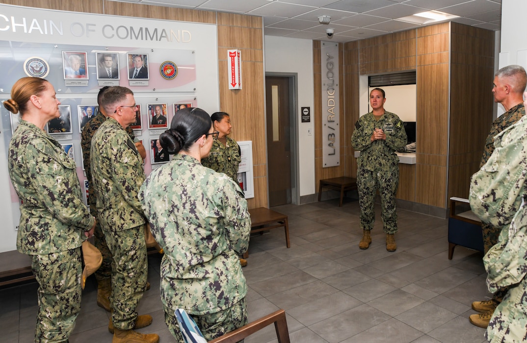 251022-N-FB730-1010 CAMP LEJEUNE. (October 22, 2025) Lieutenant Commander Amber Love, Camp Johnson Branch Medical Clinic department head, leads a tour of the facility after the ribbon cutting ceremony for the new branch medical clinic aboard Camp Johnson, on October 22, 2025. Camp Johnson Branch Medical Clinic is an active duty clinic that provides care for all military members aboard Camp Johnson base including permanent personnel and students. (U.S. Navy photo by Mass Communications Specialist second class Justin Woods)
