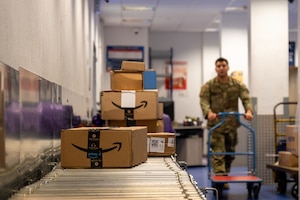 Airman 1st Class Luis Alvarez, 786th Force Support Squadron postal clerk, offloads incoming packages at the Northside Post Office on Ramstein Air Base, Germany, Nov. 7, 2025.