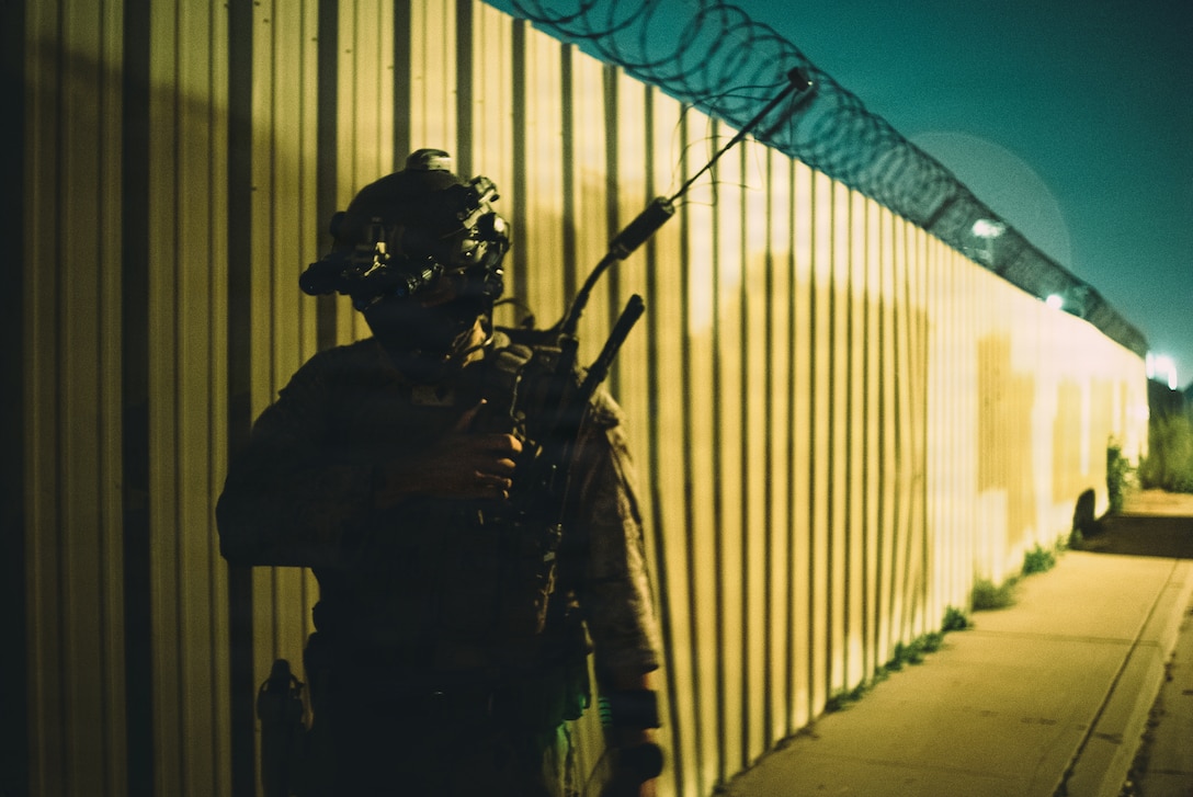 U.S. Marine Corps Sgt. Israel Velasquez, a radio operator with the Maritime Raid Force, 11th Marine Expeditionary Unit, monitors communications during a night raid as part of Realistic Urban Training in Glendale, Arizona, Nov. 10, 2025. RUT is a land-based training exercise that enables the 11th MEU to conduct expeditionary operations as a cohesive Marine Air-Ground Task Force in preparation for amphibious operations alongside the U.S. Navy. (U.S. Marine Corps photo by Sgt. Joseph Helms)