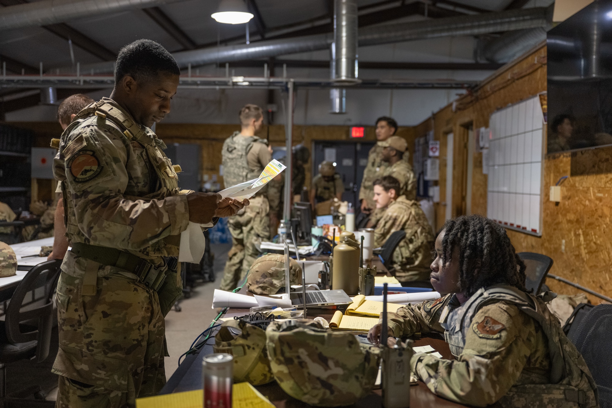 U.S. Airmen assigned to the 7th Security Forces Squadron and 7th Civil Engineer Squadron  plan operations during exercise Coyote Shield at Dyess Air Force Base, Texas, Oct. 16, 2025. Coyote Shield was designed to exceed a 96-hour readiness training event requirement. (U.S. Air Force photo by Airman 1st Class Caleb Schellenberg)