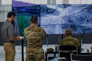 Soldiers assigned to U.S. Army Central and a representative of a Non-Government Organization (NGO) examine humanitarian aid routes in the Civil-Military Coordination Center (CMCC) on Nov. 11, 2025, in Israel. The CMCC is designed to help facilitate the flow of humanitarian, logistical, and security assistance into Gaza and monitors the implementation of the ceasefire agreement and transition to civilian governance. (U.S. Army photo by Spc. Kathryn Skonning)