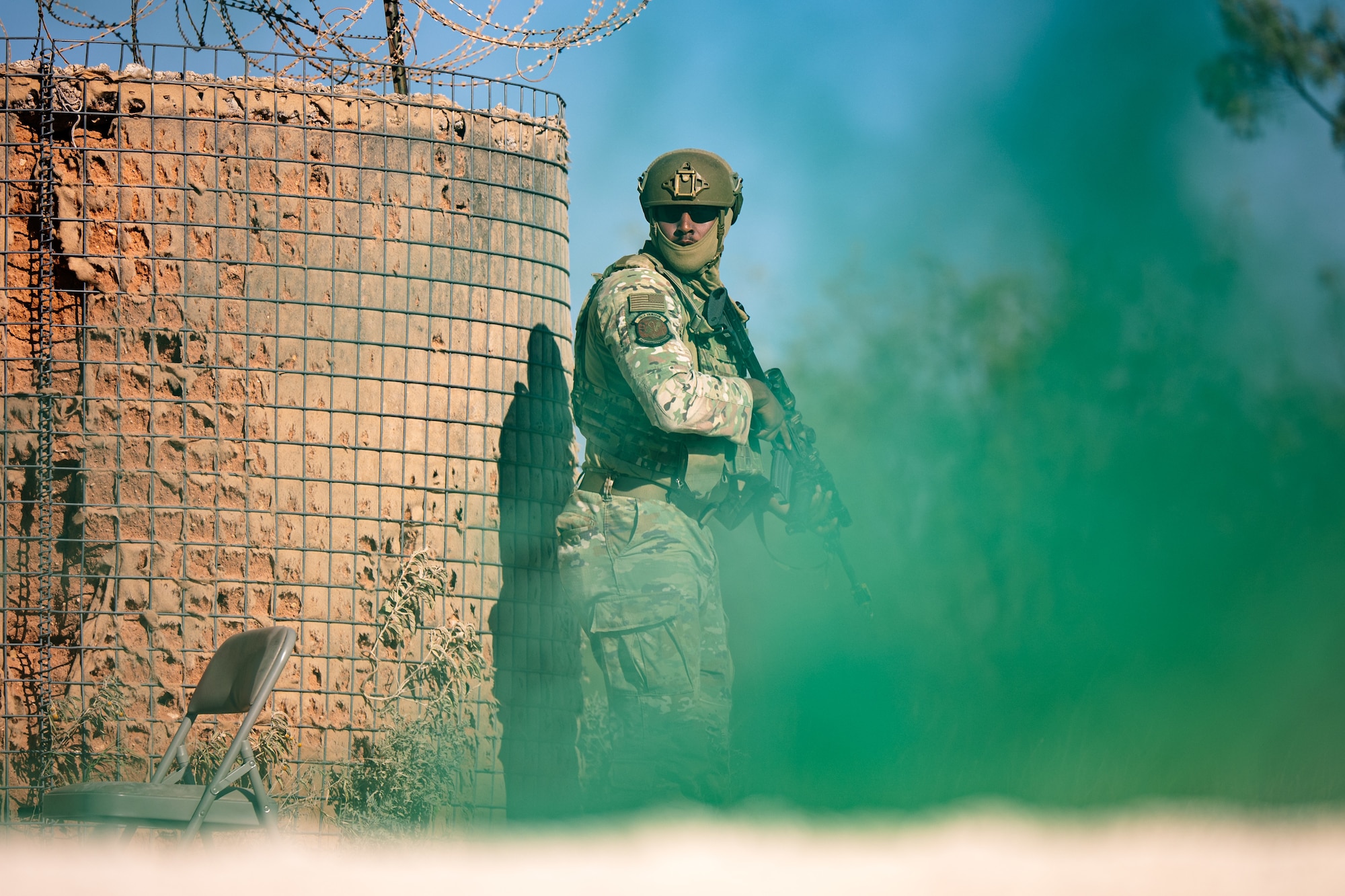 U.S. Air Force Airman 1st Class Joseph Suarez, 7th Security Forces Squadron member, takes cover from opposing forces during exercise Coyote Shield at Dyess Air Force Base, Texas, Oct. 17, 2025. Through Coyote Shield, Airmen from the 7th Civil Engineer Squadron and 7th SFS honed their skills in recovering base operations, receiving follow-on support, and re-establishing command and control, strengthening the 7th Bomb Wing's readiness in limited environments. (U.S. Air Force photo by Senior Airman Jade M. Caldwell)