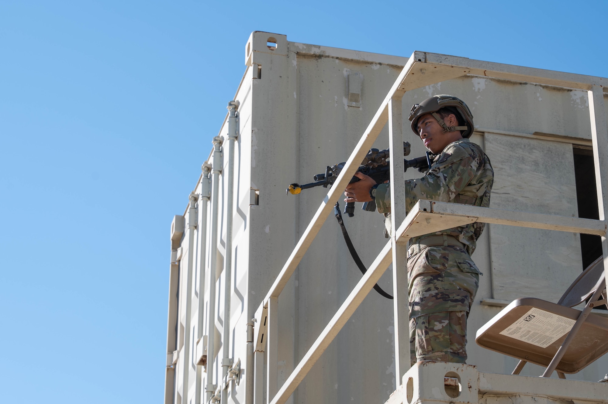 U.S. Air Force Airman 1st Class Noah Dinh, 7th Security Forces Squadron member, looks for opposing forces during exercise Coyote Shield at Dyess Air Force Base, Texas, Oct. 17, 2025. Coyote Shield highlighted the Department of the Air Force's commitment to security by integrating counter-Small Unmanned Aircraft Systems capabilities with traditional defense, communications, and asset safeguarding, showcasing a layered defense approach to protecting installations and personnel. (U.S. Air Force photo by Airman William Neal)