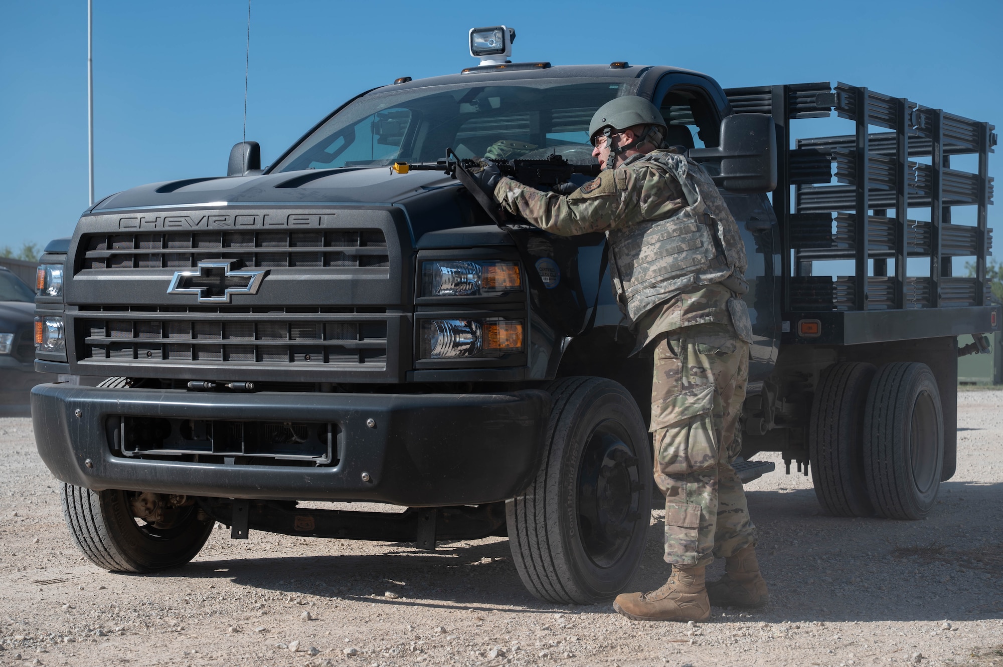 U.S. Air Force Tech. Sgt. Waynick Rooney, 7th Civil Engineer Squadron electrical craftsman, takes cover from opposing forces during exercise Coyote Shield at Dyess Air Force Base, Texas, Oct. 17, 2025. Coyote Shield provided Airmen from the 7th CES and 7th Security Forces Squadron valuable dual training opportunities, ensuring 7th Bomb Wing Airmen remain ready for any mission. (U.S. Air Force photo by Airman William Neal)