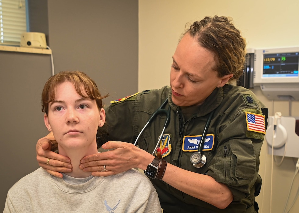 Image of an Airman treating a patient.