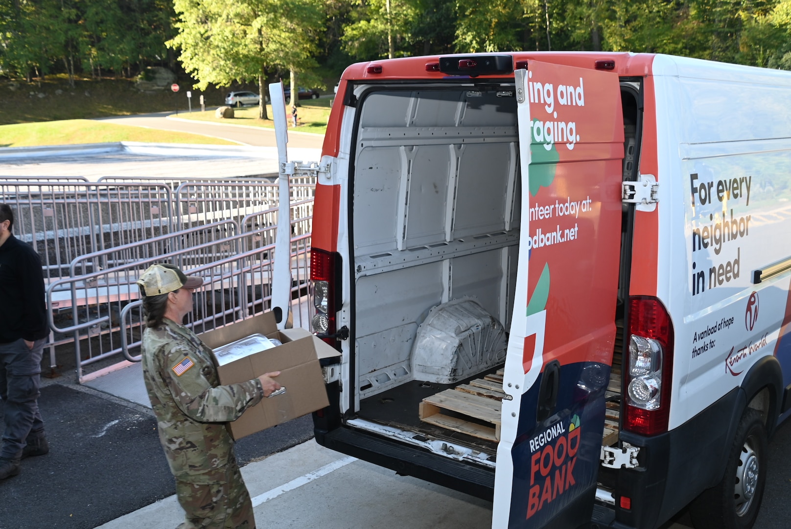 Capt. Jacquelyn Contant, Chief, Nutrition Care Division, Keller Army Community Hospital, delivers the box of frozen repurpose prepared and wholesome foods to the Regional Food Bank of New York vehicle.