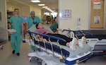 A simulated patient is moved from the emergency department to an operating room as part of the San Antonio Mass Casualty Exercise and Evaluation at Brooke Army Medical Center, Joint Base San Antonio-Fort Sam Houston, Texas, Oct. 15, 2025. During the exercise, patients (role players) were transferred from the emergency department to the operating room, then to inpatient wards to test the movement process.