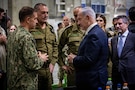 Adm. Brad Cooper, commander of U.S. Central Command, and members of the Israeli Defense Forces discuss logistics with Israeli Prime Minister Benjamin Nentanyahu inside the Civil-Military Coordination Center (CMCC) on Oct. 29, 2025, in Israel. (U.S. Army photo by Staff Sgt. Michael Ito)