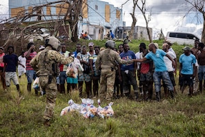 Military and civilian people greet each other