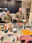 Air Force trainees Hayden Schulze (left) and Jack Canter (right) help themselves to Thanksgiving dinner on Nov. 23, 2023. Veterans Leslie and Daniel Brown have hosted trainees since 2006 as a part of Operation Home Cooking. Now in its 48th year, the program allows volunteer families residing in the San Antonio Metropolitan area the opportunity to share the holiday with trainees who are in their sixth or seventh week of basic training. (Courtesy photo)