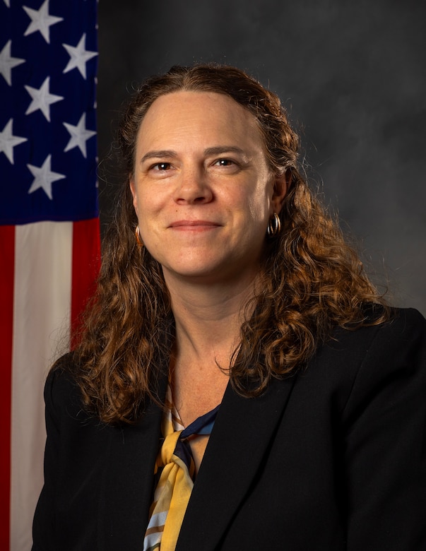 Marjorie Schmitt, DCRM, MCSC, posed in front of the American flag.
