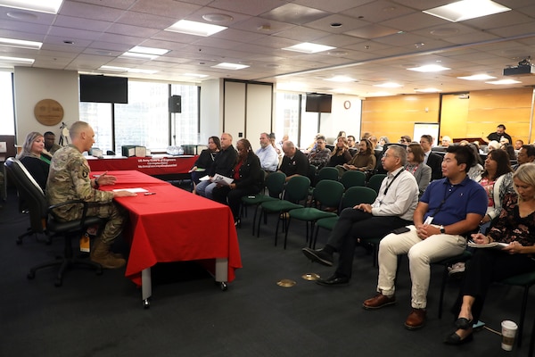 Col. Andrew Baker, Los Angeles District commander, second from left, delivers remarks during the End of Fiscal Year 2025 Town Hall and Awards Celebration Oct. 16 in downtown LA.