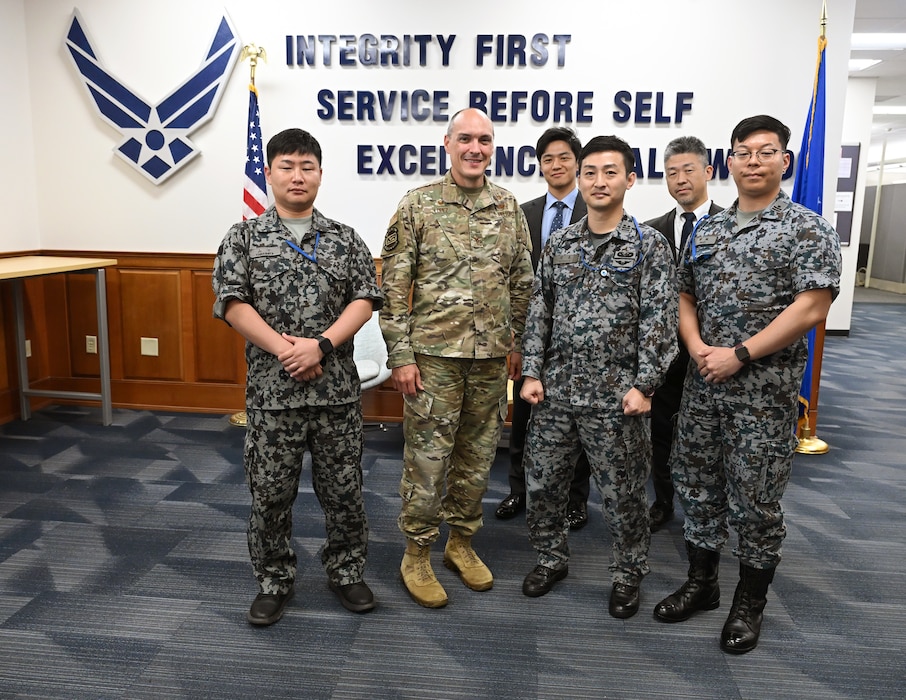 Col. Richard Lopez poses for a photograph with Japanese Air Self Defense Force delegates, here, Sept. 29, 2025. The delegates traveled to Hanscom Air Force Base to learn about the Department of the Air Force’s Program Executive Office for Command, Control, Communications and Battle Management’s divisions and how they connect into the DAF BATTLE NETWORK. Lopez is Kessel Run’s senior materiel leader. (Official Air Force Photo by Richard Blumenstein)