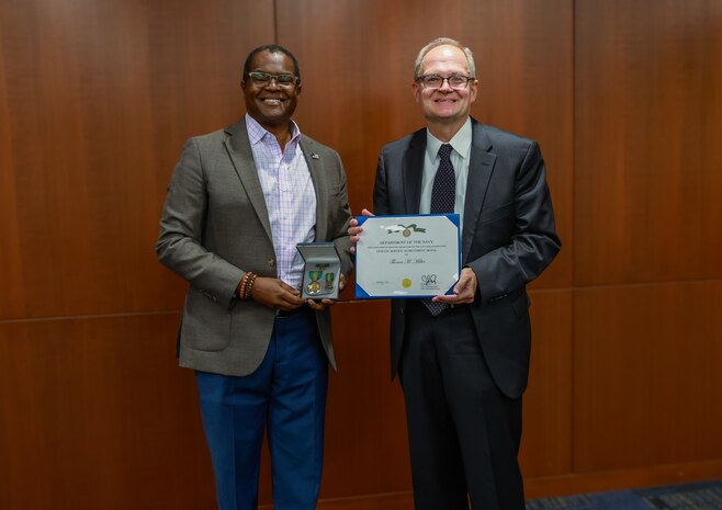 NSWCPD Technical Director Nigel C. Thijs, SES, presents Thomas M. Miller with the Department of the Navy Civilian Service Achievement Medal in recognition of his exceptional professional achievement as the Machinery Silencing RDT&E Lead for the Columbia Class Submarine Program. Throughout his 40-year career, Miller’s visionary leadership and technical expertise were instrumental in advancing submarine stealth through innovative quieting technologies and methodologies—critical to maintaining the U.S. Navy’s strategic advantage in undersea warfare. (U.S. Navy photo by Jay Butterbaugh, CTR)