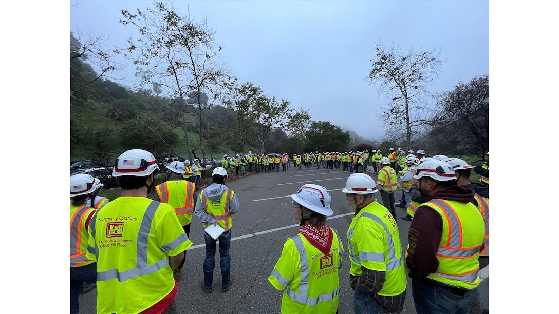 QAs meet for their morning meeting in a parking lot in Pacific Palisades, Calif., April 12, 2025.  These QAs were working the Palisades debris removal mission, part of the USACE Southern California wildfires recovery mission after wildfires burned parts of Los Angeles in January 2025. Photo by Forrest Luna.