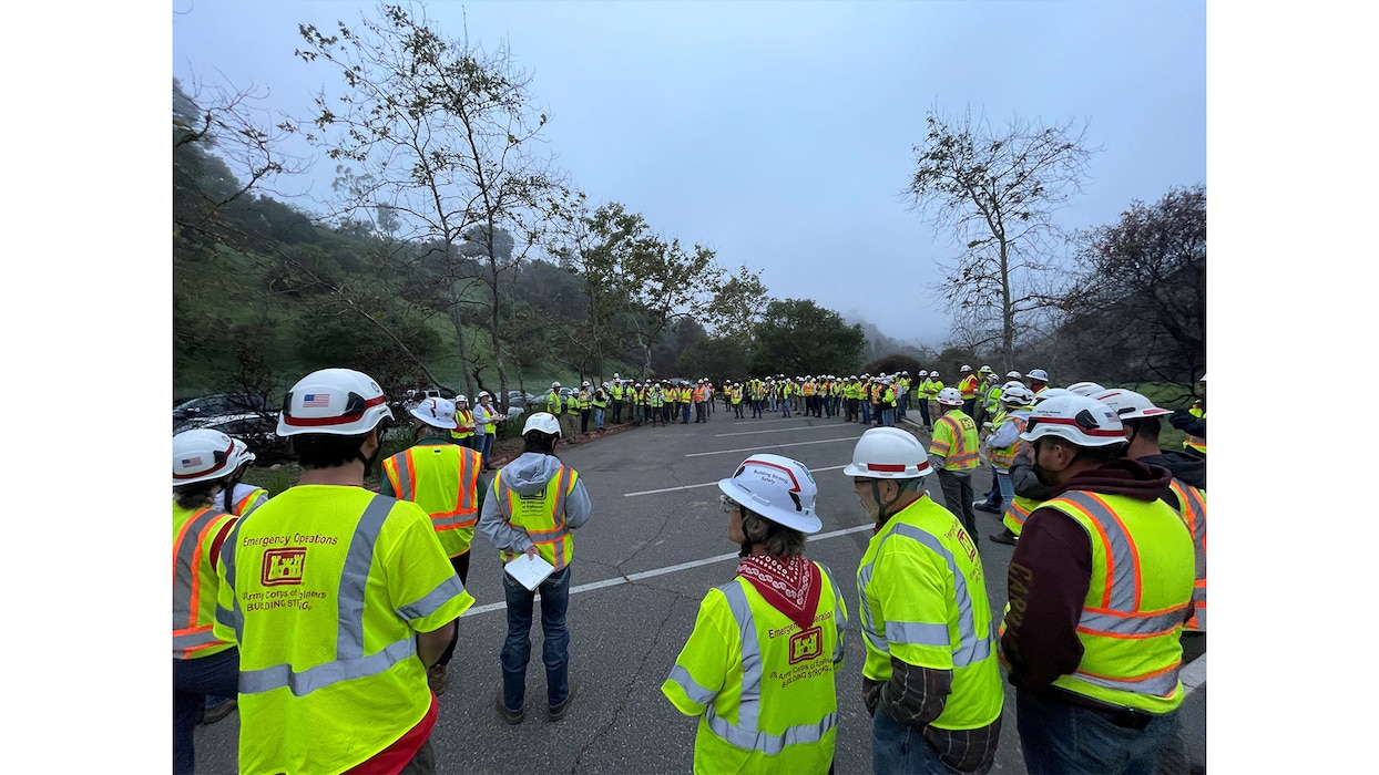 QAs meet for their morning meeting in a parking lot in Pacific Palisades, Calif., April 12, 2025.  These QAs were working the Palisades debris removal mission, part of the USACE Southern California wildfires recovery mission after wildfires burned parts of Los Angeles in January 2025. Photo by Forrest Luna.