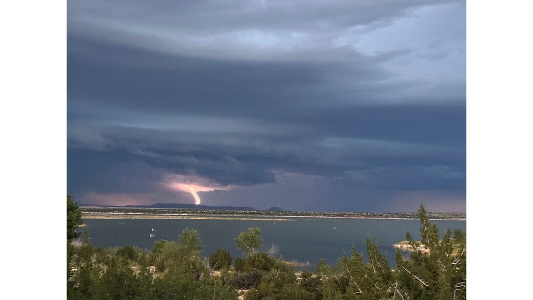 Lightning strikes Alligator Mountain during a storm, Aug. 1, 2025. Santa Rosa Lake, N.M., is seen in the foreground.  Photo by Paul Sanchez.