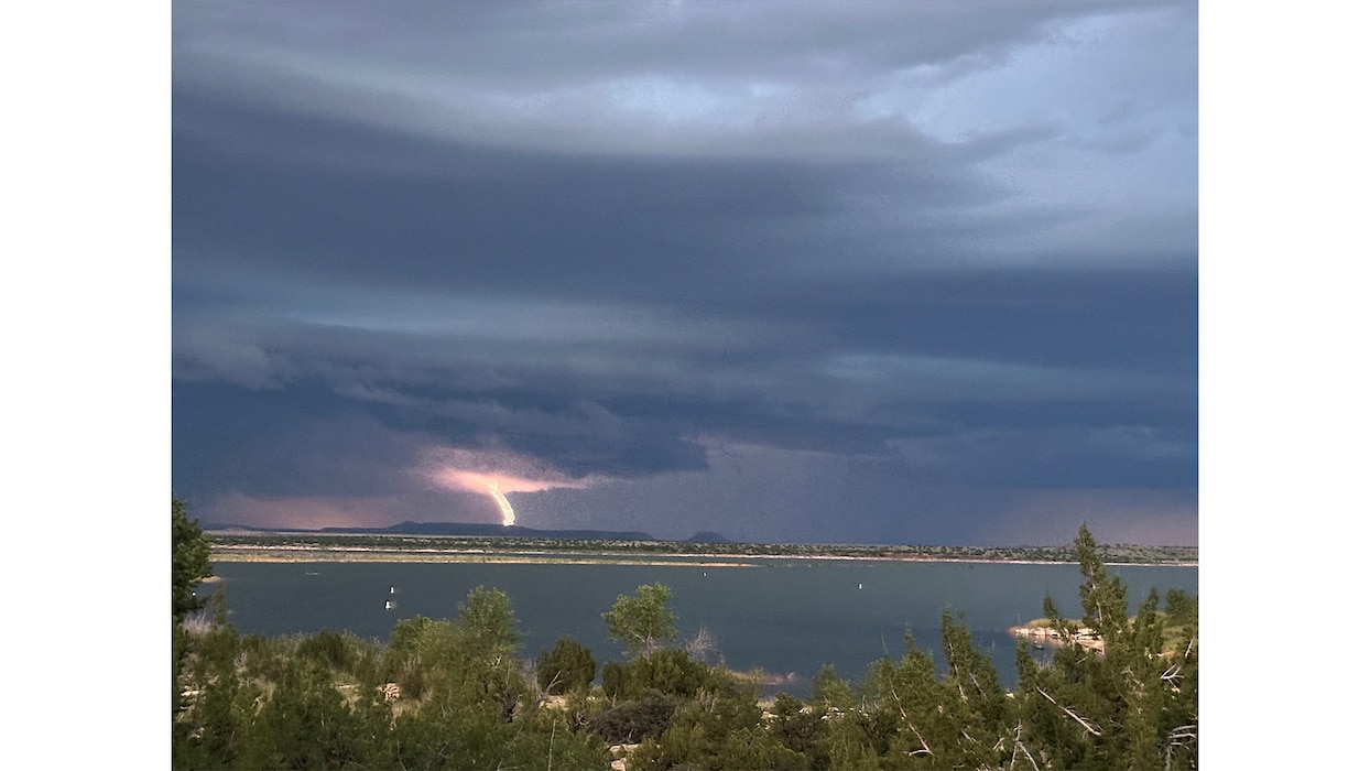 Lightning strikes Alligator Mountain during a storm, Aug. 1, 2025. Santa Rosa Lake, N.M., is seen in the foreground.  Photo by Paul Sanchez.