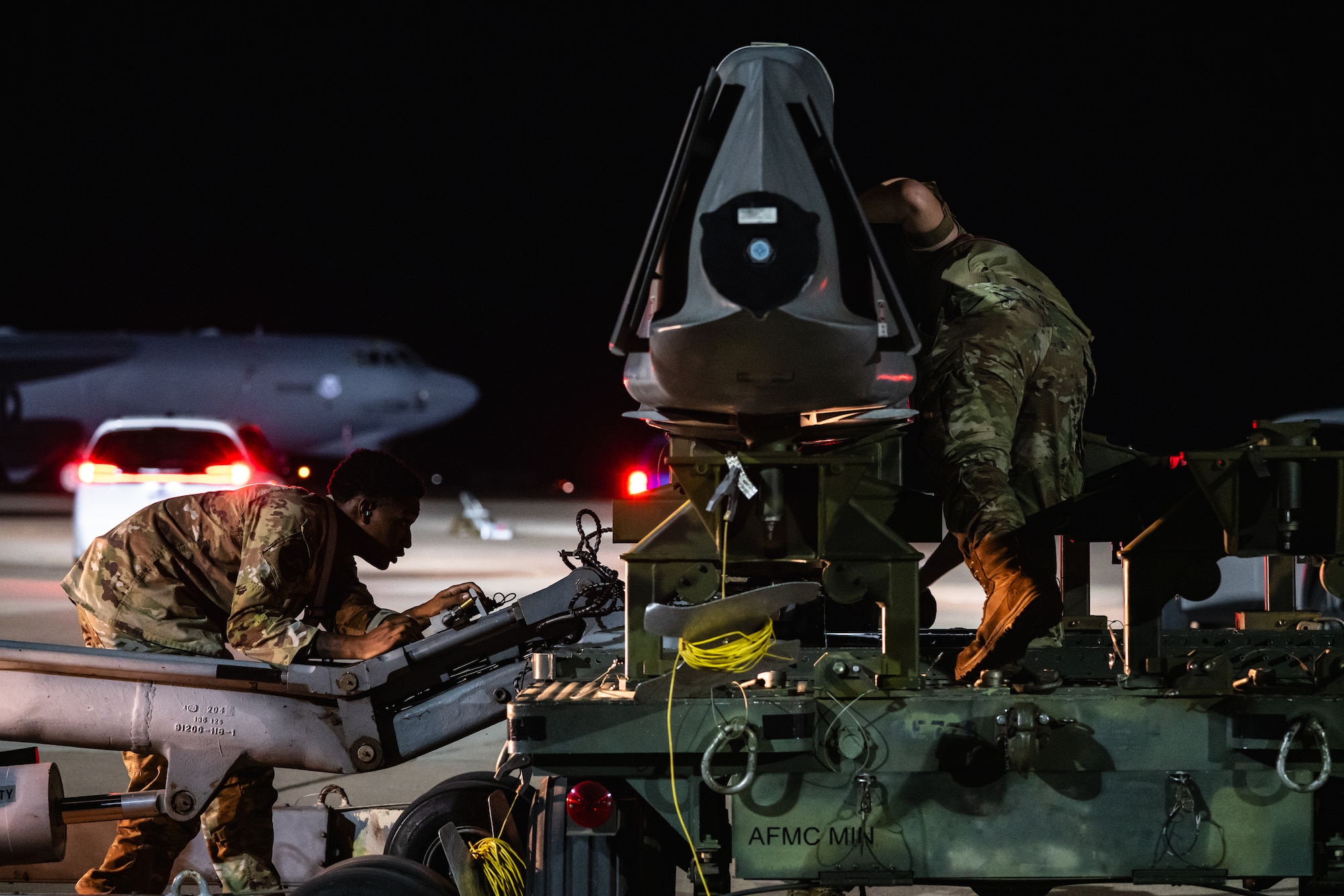 U.S. Airmen assigned to Air Force Global Strike Command, prepare a training munition for load as part of Exercise Global Thunder 26 at Dyess Air Force Base, Texas, Oct. 28, 2025. Global Thunder is an annual command and control exercise designed to train U.S. Strategic Command Forces and assess joint operational readiness. (U.S. Air Force photo by Senior Airman Jade M. Caldwell)