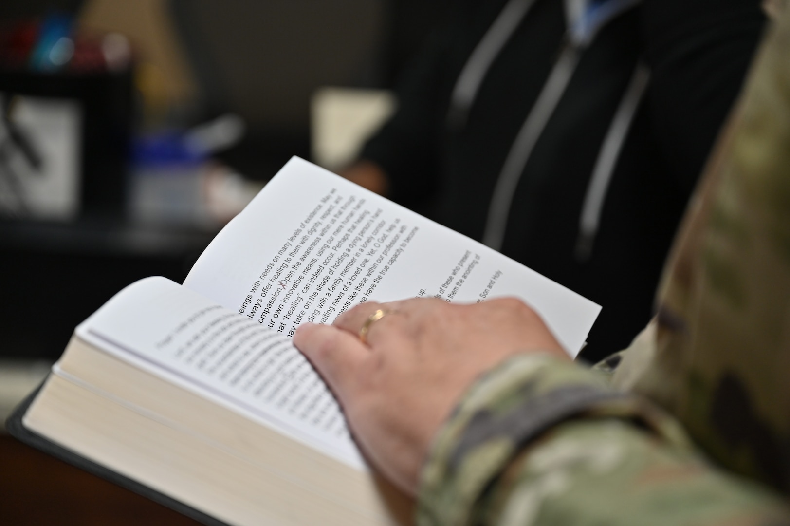 Chaplain (Capt.) Steven Troupe points to a passage in the Bible while reading during a Blessing of the Hands ceremony at Carl R. Darnall Army Medical Center on Fort Hood, Texas.