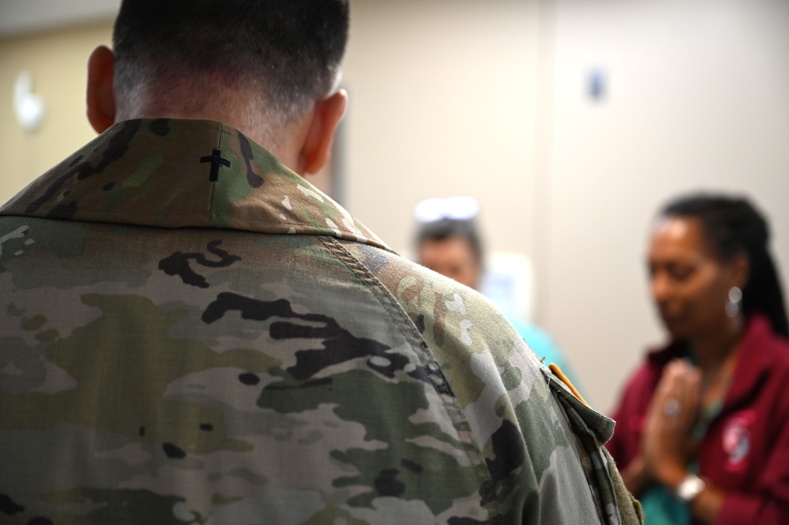 Chaplain (Capt.) Steven Troupe prays with staff members during a Blessing of the Hands ceremony at Carl R. Darnall Army Medical Center on Fort Hood, Texas. The prayer is part of the ceremony that acknowledges the contributions of health care staff.