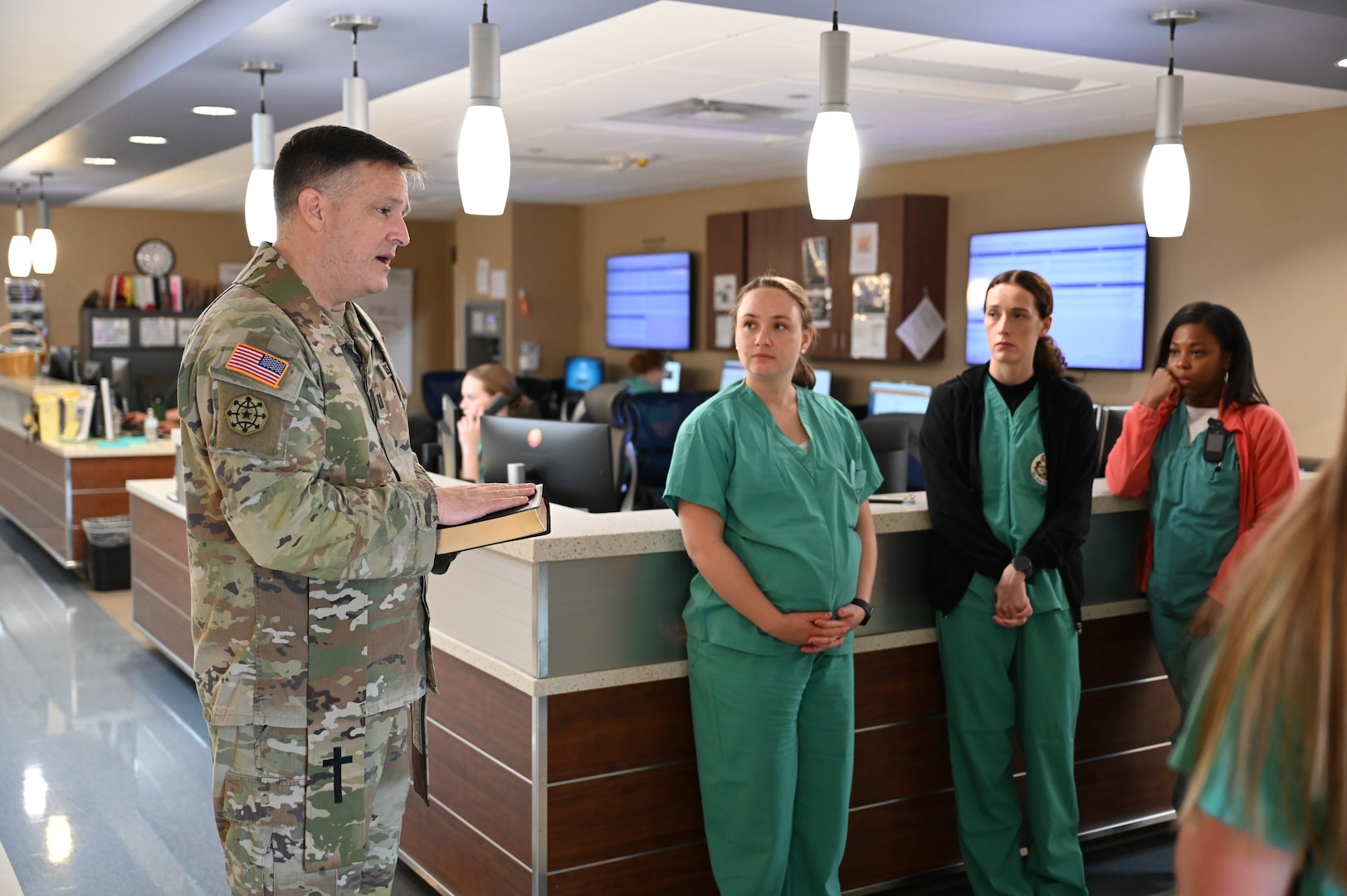 Chaplain (Capt.) Steven Troupe, Carl R. Darnall Army Medical Center, Fort Hood, Texas, explains the meaning and purpose of the Blessing of the Hands ceremony to participants before beginning the event. The chaplain shared how the tradition honors the healing role of medical staff and reminds them of the compassion and service they provide every day.