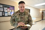 Chaplain (Capt.) Steven Troupe reads from his Bible as he offers a prayer during the Blessing of the Hands ceremony at Carl R. Darnall Army Medical Center, Fort Hood, Texas.