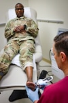 A podiatrist at Irwin Army Community Hospital applies 2,500 low-intensity soundwave pulses designed to stimulate blood flow, reduce inflammation, and encourage bone regeneration to a patient who suffered a fifth metatarsal avulsion fracture, a painful injury caused when a ligament pulled part of the bone away after he stepped into a pothole during a run.