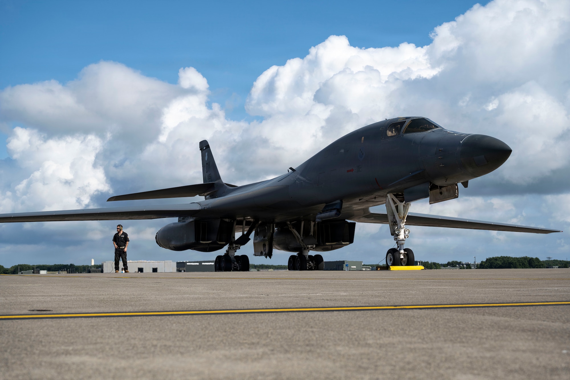 A maintainer works outside on a plane