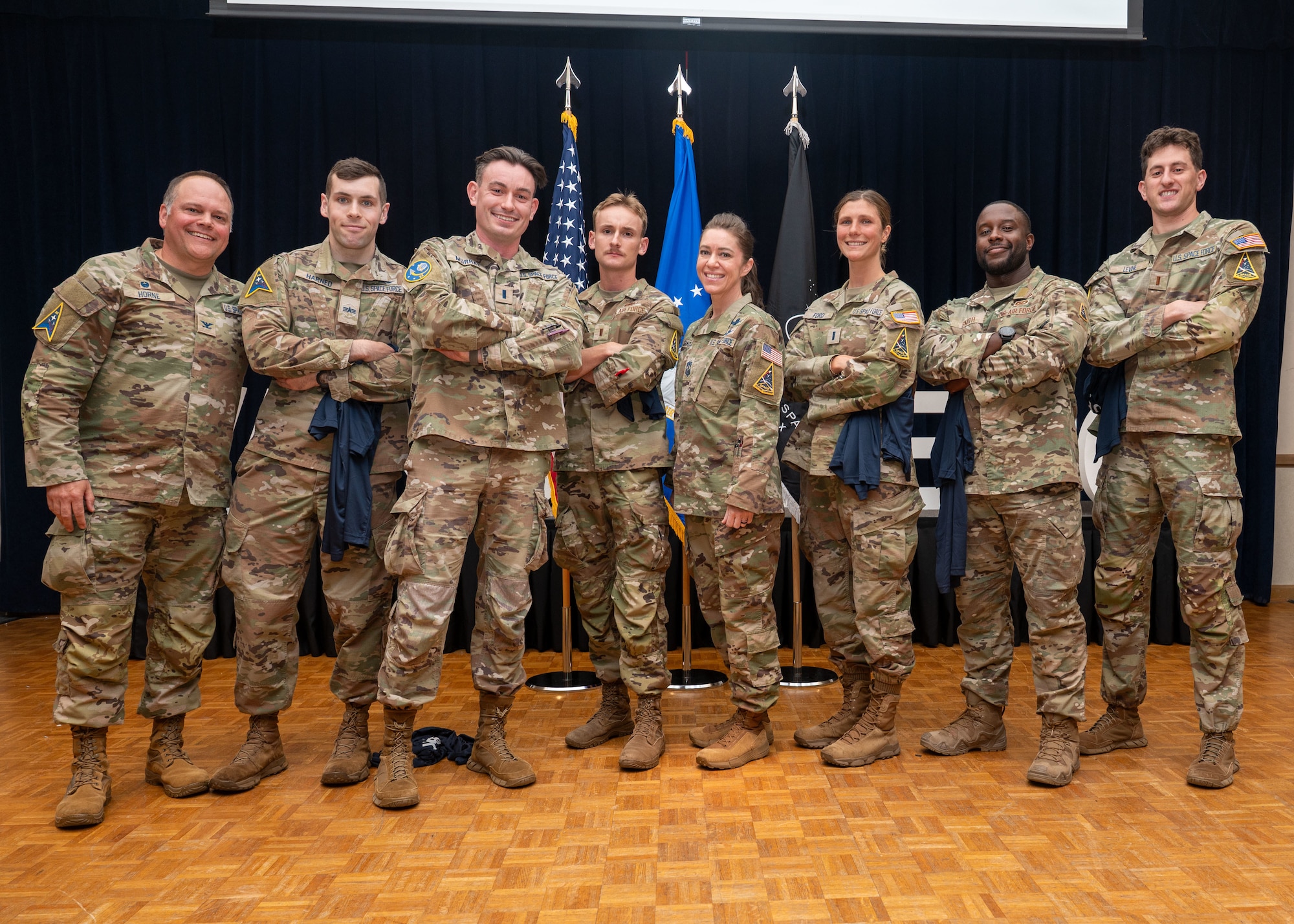 U.S. Space Force Col. James Horne III, Space Launch Delta 30 commander, left, and U.S. Space Force Chief Master Sgt. Shannan Sanchez, SLD 30 senior enlisted leader, center, stand with Team Vandenberg personnel.