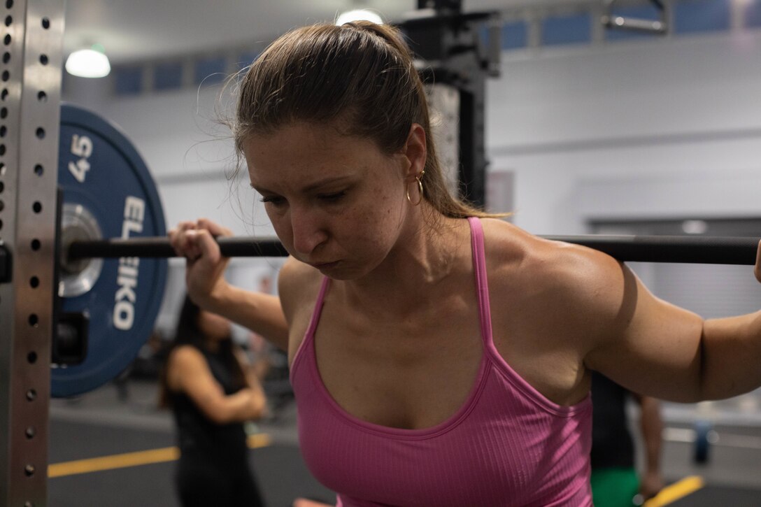 A Marine Corps Air Station Iwakuni resident executes a weighted squat during a women’s 500–1000-pound power lifting club event at MCAS Iwakuni, Japan, Sept. 26, 2025. This event invited women at MCAS Iwakuni to challenge themselves in weighted squats, bench, and deadlifts. (U.S. Marine Corps photo by Lance Cpl. Siwan Lewis)