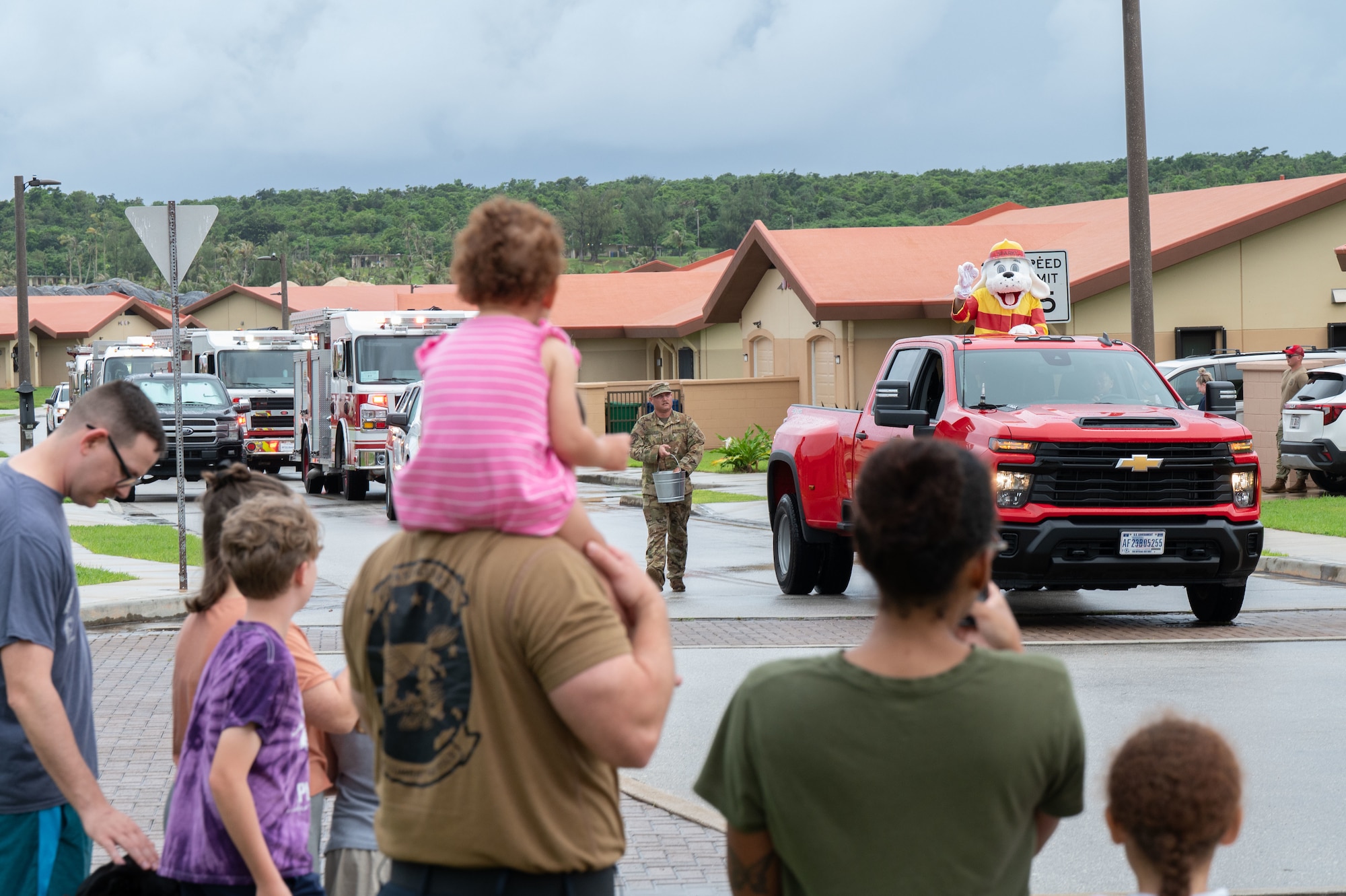 Attendees watch as the 36th Civil Engineer Squadron Fire Department passes by during the 2025 Fire Prevention Week Housing Parade at Andersen Air Force Base, Guam, Oct. 7, 2025.