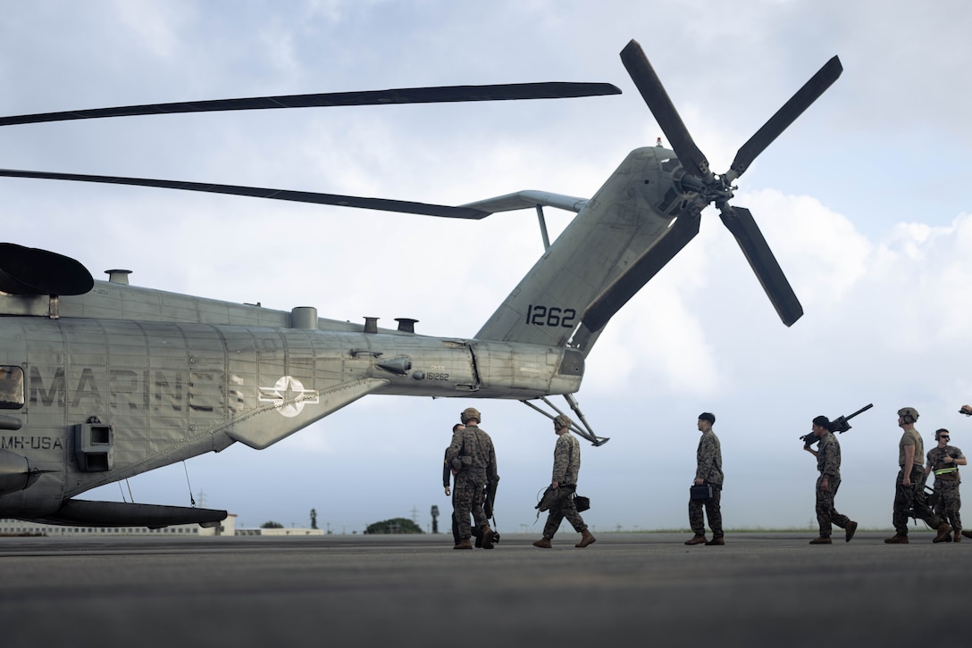 U.S. Marines with Battalion Landing Team 1st Battalion, 7th Marine Regiment, 31st Marine Expeditionary Unit, load equipment onto a U.S. Marine Corps CH53-E Super Stallion assigned to Marine Medium Tiltrotor Squadron (VMM) 265 (Rein.), 31st MEU, during flight operations at Marine Corps Air Station Futenma, Okinawa, Japan, Sept. 26, 2025. The Marines conducted flight operations demonstrating multi-domain transport capabilities to support combined-joint all domain operations. The 31st MEU, the Marine Corps’ only continuously forward-deployed MEU, provides a flexible and lethal force, ready to perform a wide range of military operations as the premiere crisis response force in the Indo-Pacific region. (U.S. Marine Corps photo by Sgt. Angel Diaz Montes De Oca)
