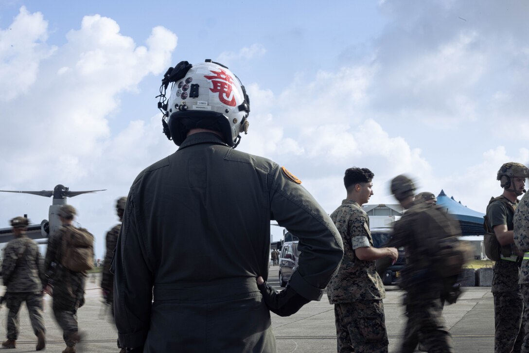 U.S. Marines with Battalion Landing Team 1st Battalion, 7th Marine Regiment, 31st Marine Expeditionary Unit, prepare to load onto a U.S. Marine Corps MV-22B Osprey assigned to Marine Medium Tiltrotor Squadron (VMM) 265 (Rein.), 31st MEU, during flight operations at Marine Corps Air Station Futenma, Okinawa, Japan, Sept. 26, 2025. The Marines conducted flight operations demonstrating multi-domain transport capabilities to support combined-joint all domain operations. The 31st MEU, the Marine Corps’ only continuously forward-deployed MEU, provides a flexible and lethal force, ready to perform a wide range of military operations as the premiere crisis response force in the Indo-Pacific region. (U.S. Marine Corps photo by Sgt. Angel Diaz Montes De Oca)