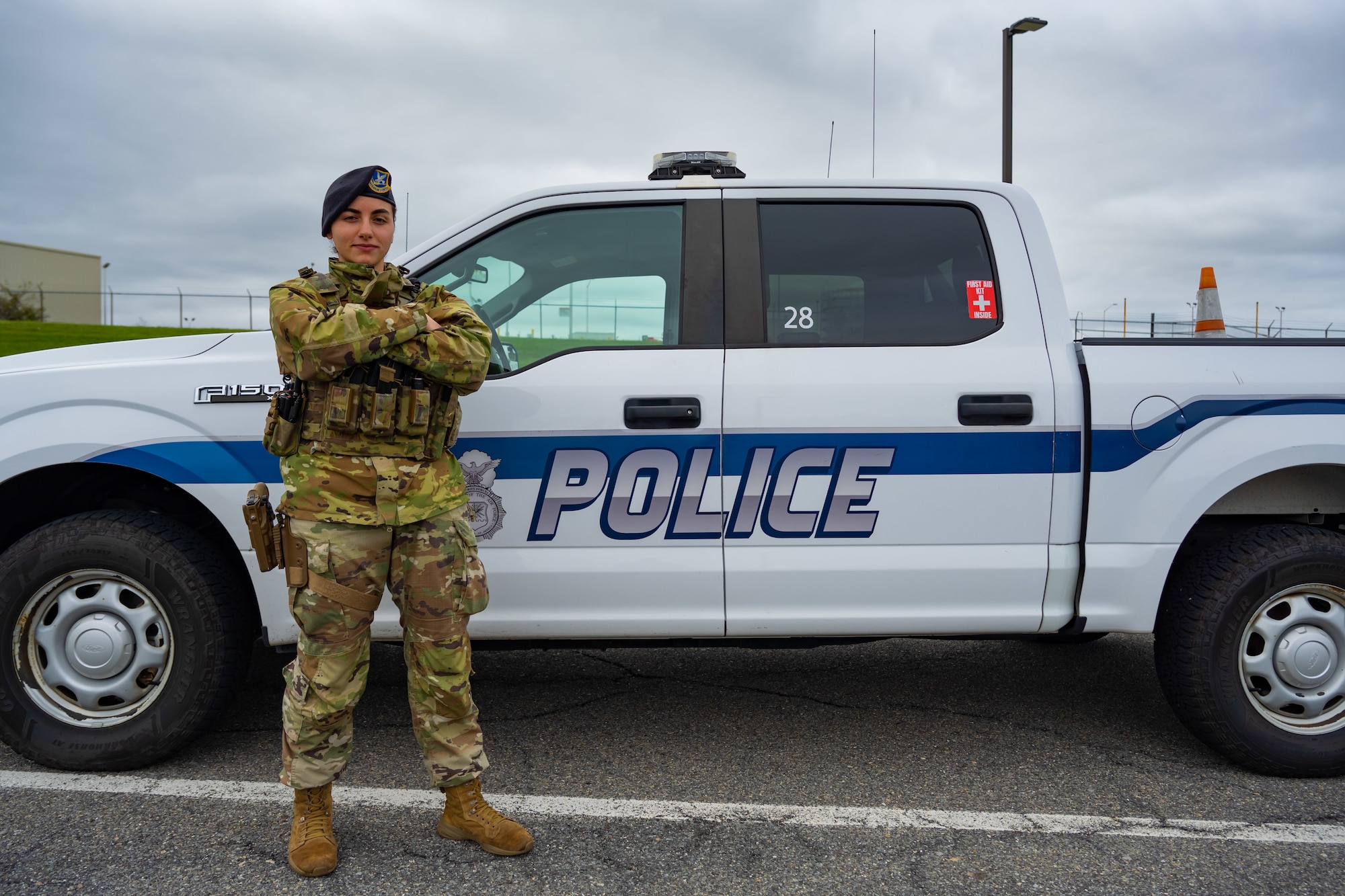 A1C Tinatin Sadzaglishvili poses for a photo next to a 105th Base Defense Group police truck.
